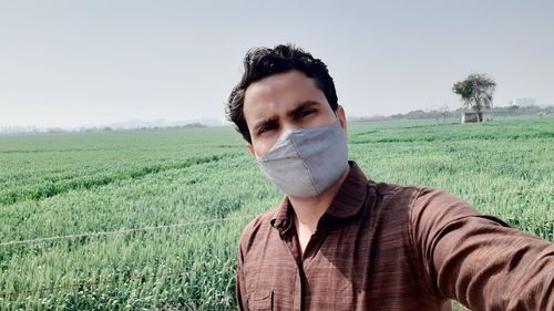 Portrait of young man in field