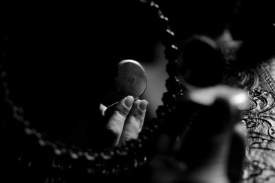 Close-up of human hand against black background