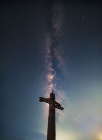 Low angle view of lighthouse against sky at night