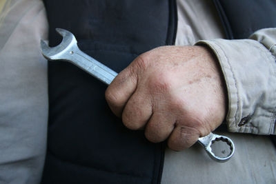 Close up of man holding a tool