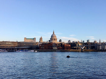 River in city against clear sky