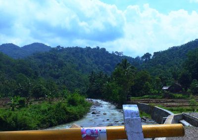 Scenic view of trees and mountains against sky