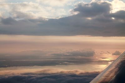 Cropped image of airplane flying over sea