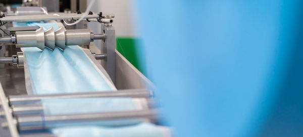 Close-up of surgical mask manufacturing in factory