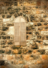 Close-up of window on wall of old building