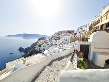 High angle view of townscape by sea against sky