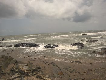 Scenic view of sea against cloudy sky