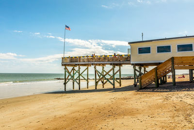 Lifeguard hut on beach against sky