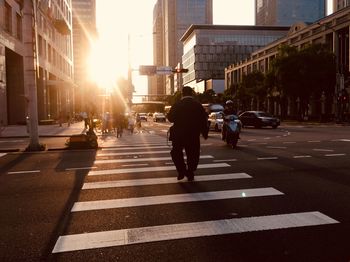 People crossing road in city