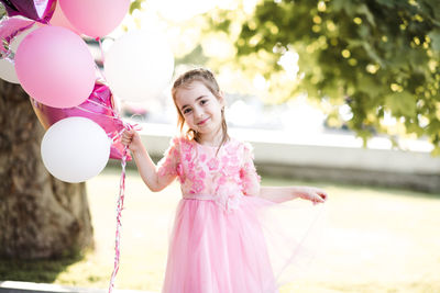 Portrait of cute girl with balloons