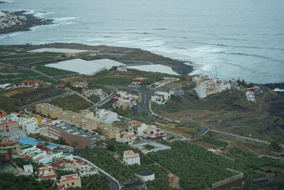 High angle view of buildings by sea