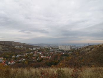 Aerial view of buildings in city against sky