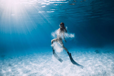 Rear view of woman swimming in sea