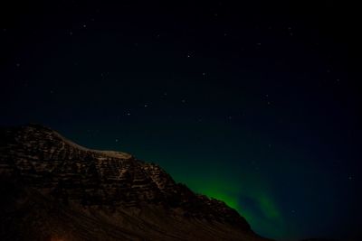 Low angle view of mountain against clear sky at night