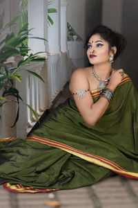 Portrait of a young woman sitting outdoors