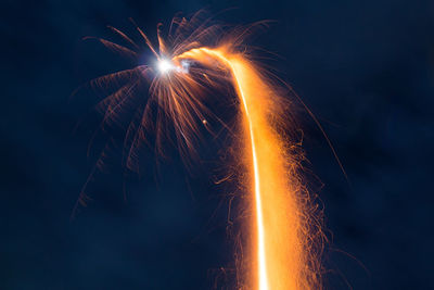 Low angle view of firework display at night