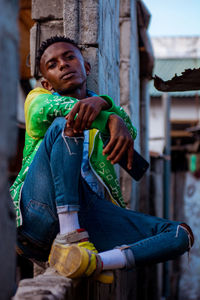 Portrait of young man sitting outdoors