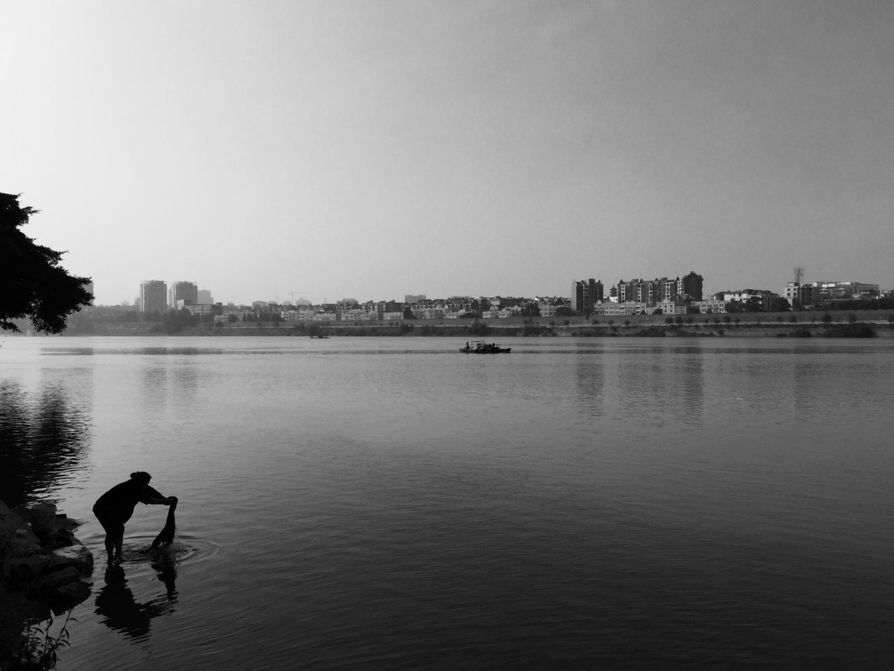 water, clear sky, copy space, building exterior, built structure, architecture, waterfront, river, city, lake, reflection, nature, cityscape, sky, rippled, sea, tranquility, outdoors, tranquil scene, no people