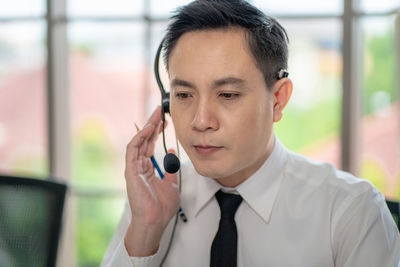 Portrait of mid adult man using mobile phone