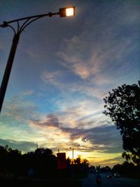 Low angle view of silhouette street against sky at sunset