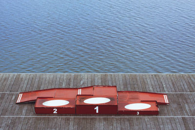 High angle view of chairs and table at lake