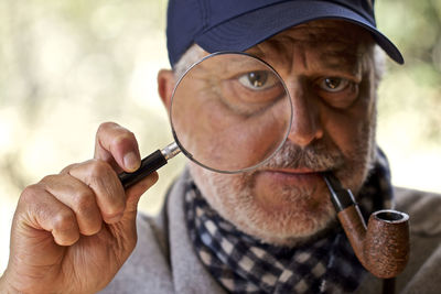 Portrait of man holding eyeglasses