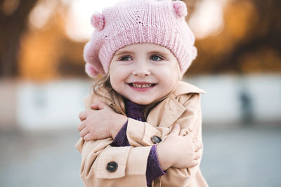 Cute girl wearing knit hat looking away