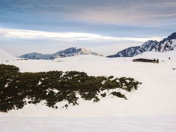 Scenic view of snow covered mountains against sky