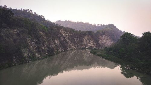 Scenic view of lake by trees against clear sky