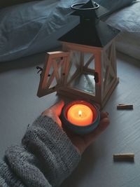 High angle view of illuminated candles on table