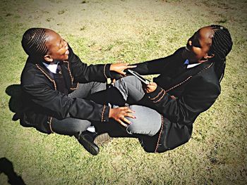 Young couple sitting outdoors