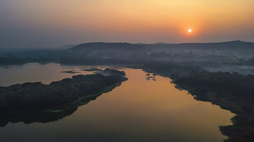 Scenic view of lake against sky during sunset