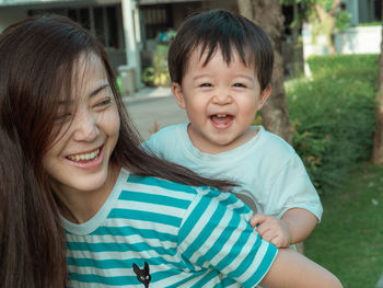 Portrait of happy smiling son with mother 