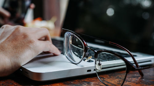 Close-up of man holding eyeglasses