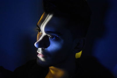 Close-up of man against black background