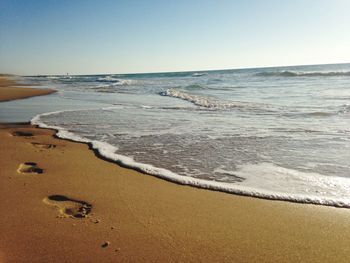 Scenic view of beach against clear sky