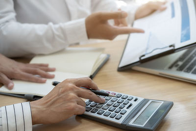 Midsection of business people working in office