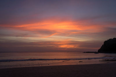 Scenic view of beach against sky during sunset