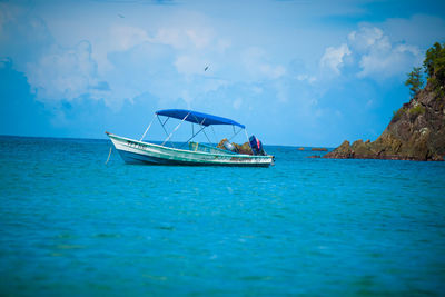 Boat in sea against blue sky