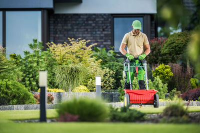 Side view of young man standing in yard