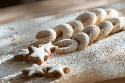 High angle view of cookies in flour on table