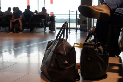 Rear view of men sitting at airport