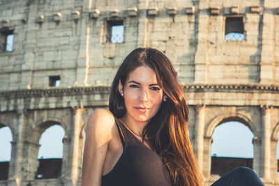 Portrait of woman against historic building