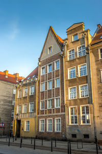 Low angle view of residential building against blue sky