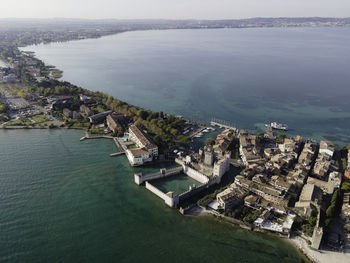 High angle view of buildings by sea