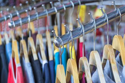 Close-up of clothes hanging on rack at store