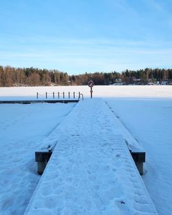 Scenic view of snow covered landscape against blue sky