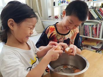 Mother and daughter holding baby at home