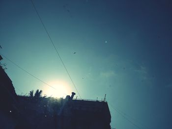 Low angle view of silhouette birds flying against sky