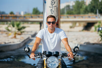 Man riding bicycle on sunglasses